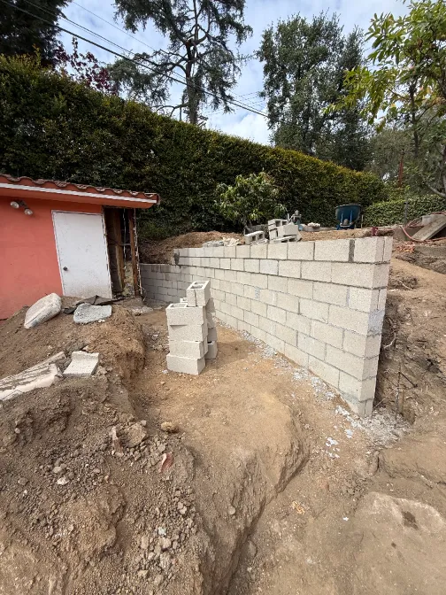 Custom Pasadena pool house foundation preparation with concrete block masonry retaining wall structure