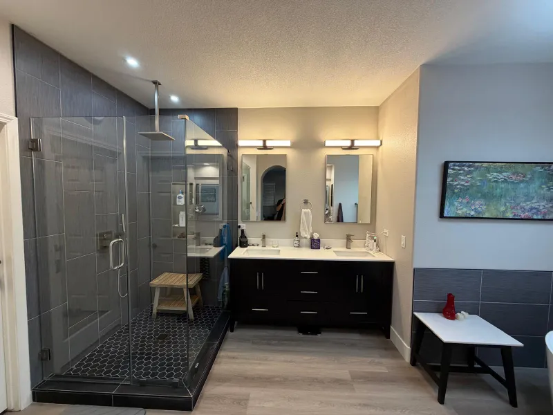 Luxury master bathroom remodel by Nikolic Construction in Temecula featuring a glass shower and double vanity